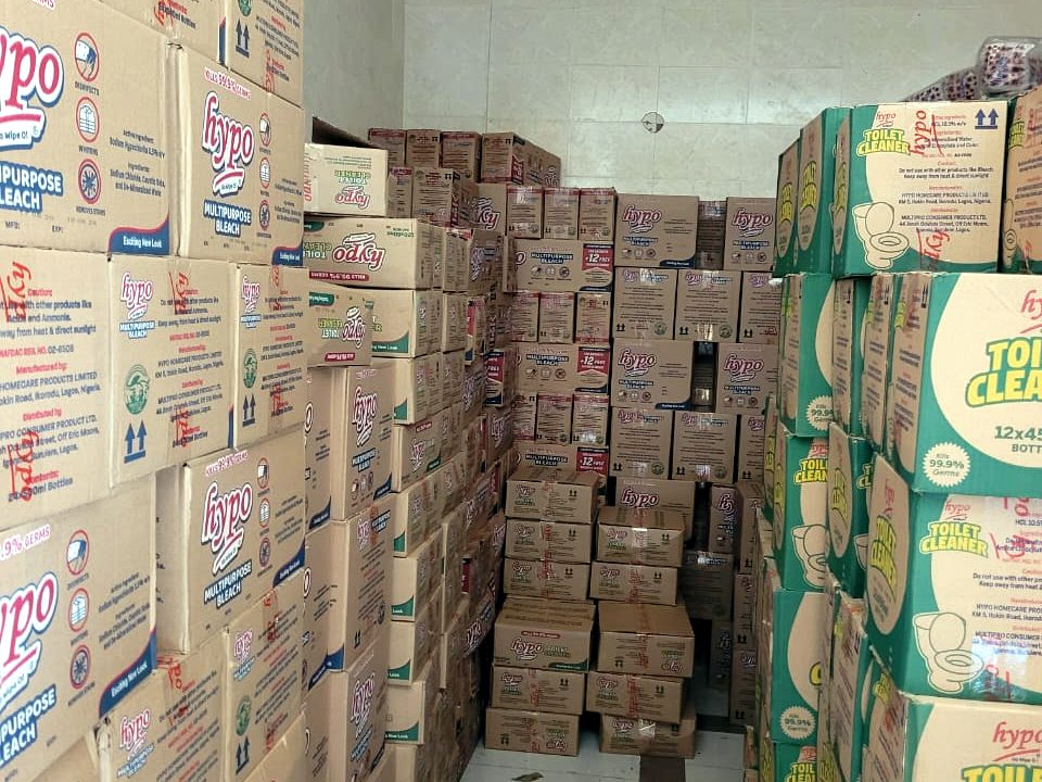 Warehouse aisle stacked with Hypo bleach and toilet cleaner cases