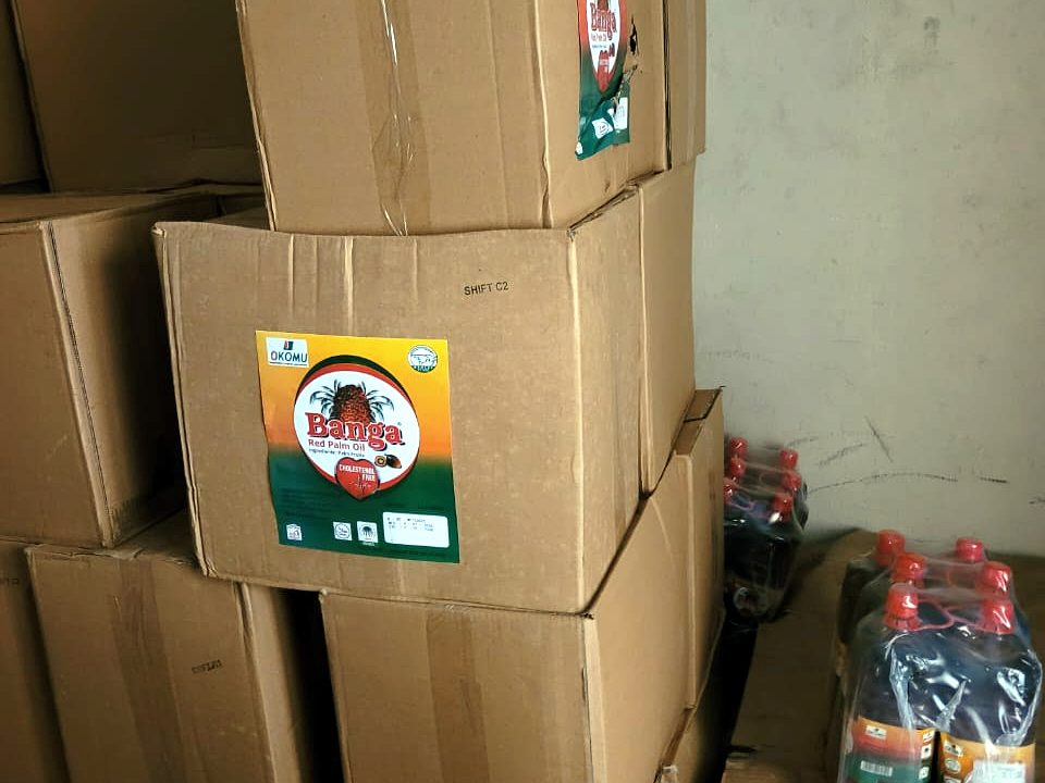 Cartons of Okomu Banga Red Palm Oil in the Homatbliss warehouse