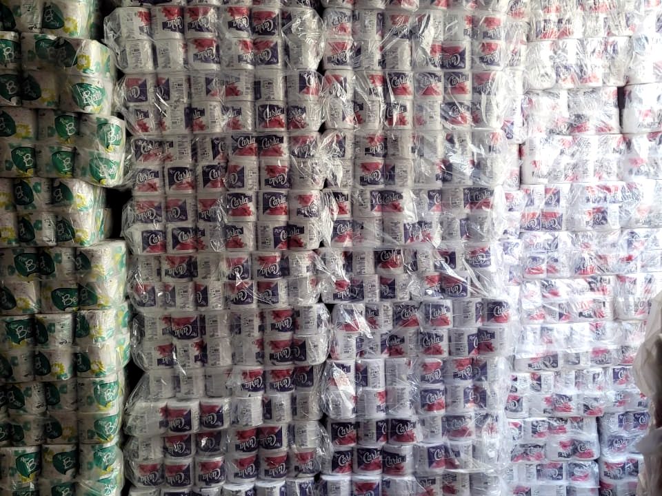 Pallets of shrink-wrapped tissue rolls stacked to the ceiling
